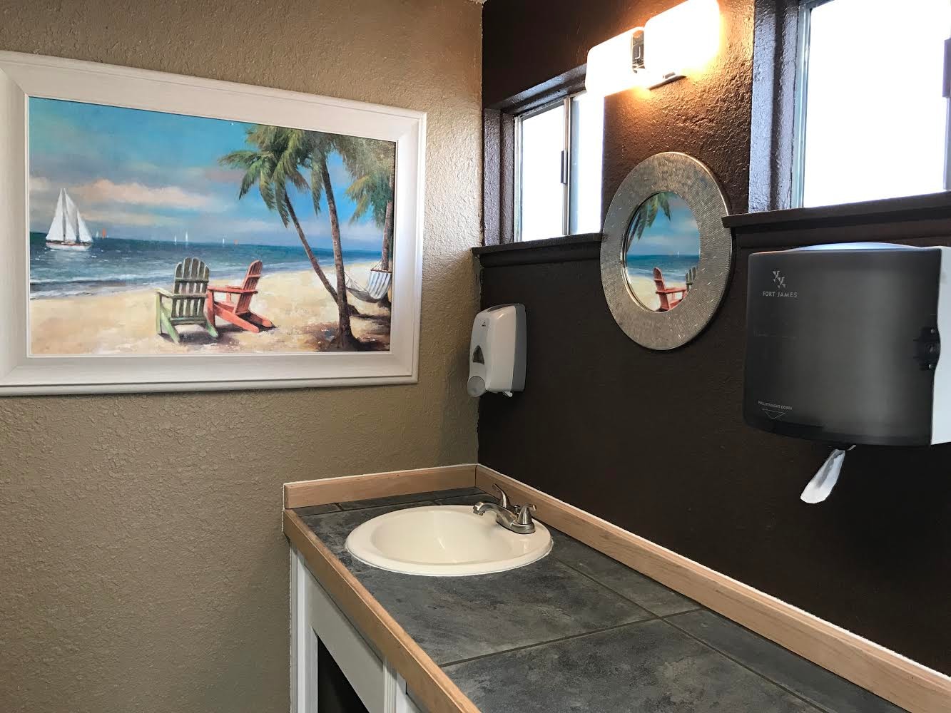 Beach-themed bathroom interior with coastal painting
