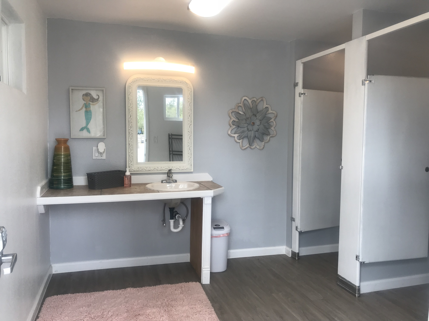 Modern bathroom with mermaid artwork and vanity